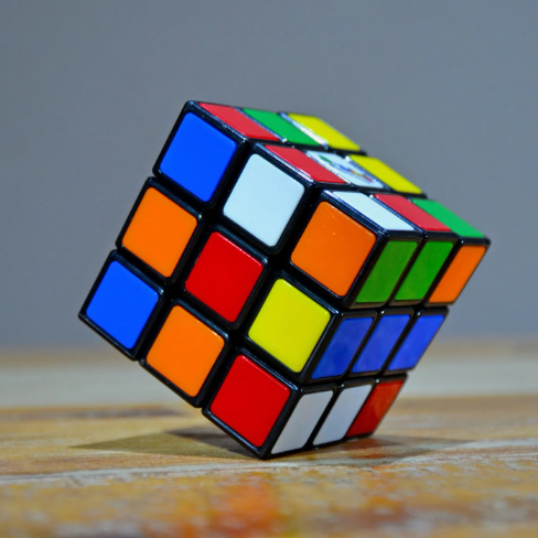 Colorful Rubik's cube resting on a wooden surface
