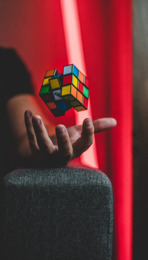 Rubik's cube tossed above an outstretched hand